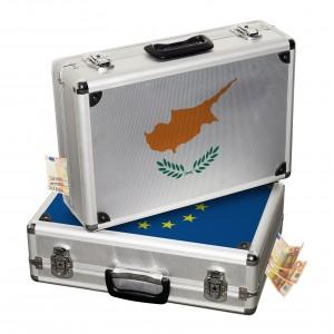 Two briefcases, one with the Cyprus flag and one with the EU flag, with money showing.