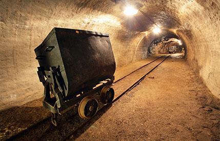 Mining cart inside an underground tunnel.