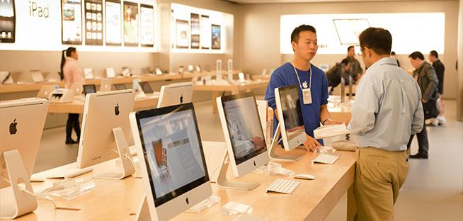 Customer service in an Apple Store, representing Apple share investment.