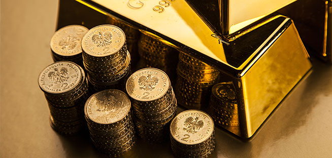 Gold bar and stacks of gold-colored coins.