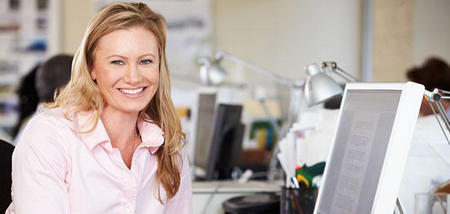 Employees discussing workplace benefits around a desk.