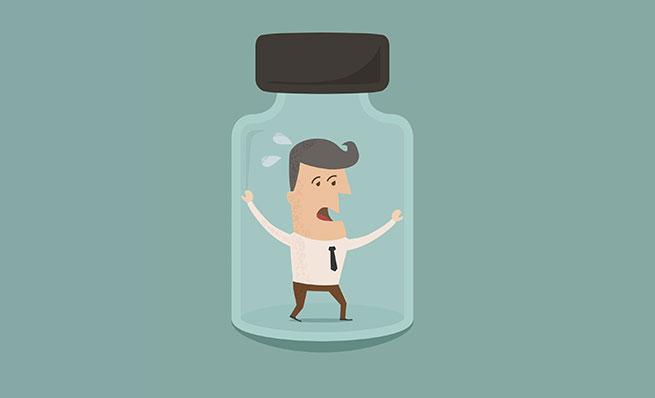 Cartoon of a sweating businessman trapped inside a glass bottle.