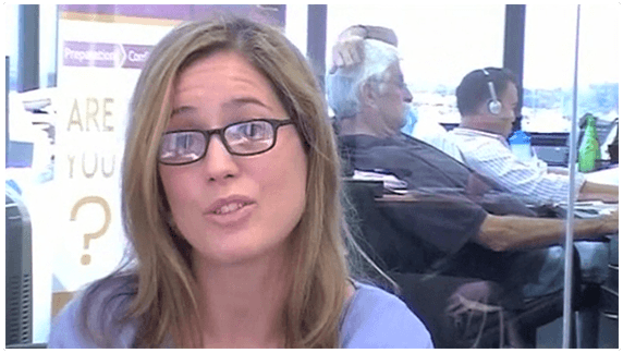 A woman named Susan wearing glasses speaks to the camera in a professional office or trading environment.