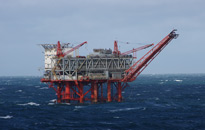 Oil rig operations with traders analyzing market data related to energy investments.