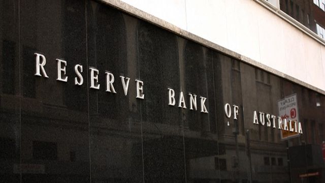 A close-up view of the exterior of a building featuring the engraved or metal lettering "RESERVE BANK OF AUSTRALIA" on its dark, glossy granite facade.